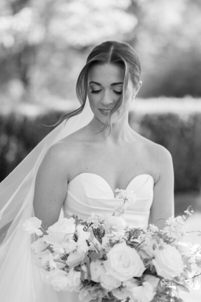 black and white photo of a groom and bride facing each other and touching foreheads, and the groom brushing the brides hair behind her ear taken by Cleveland OH wedding photographer, Kristin Leanne