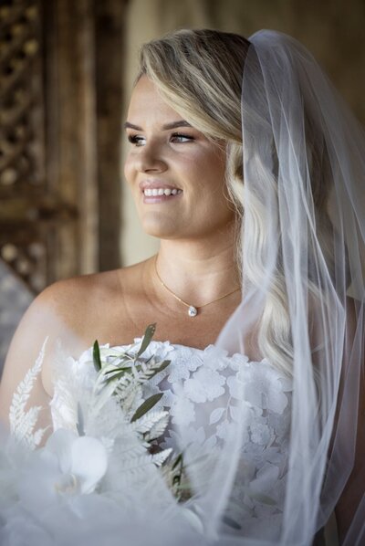Airlie Beach bride with softly defined makeup and soft waves hair
