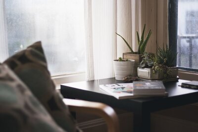 One side of a cozy home adorned with flower vases on the table