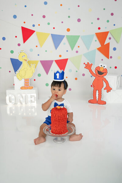 Boy eating cake with wooden spoon