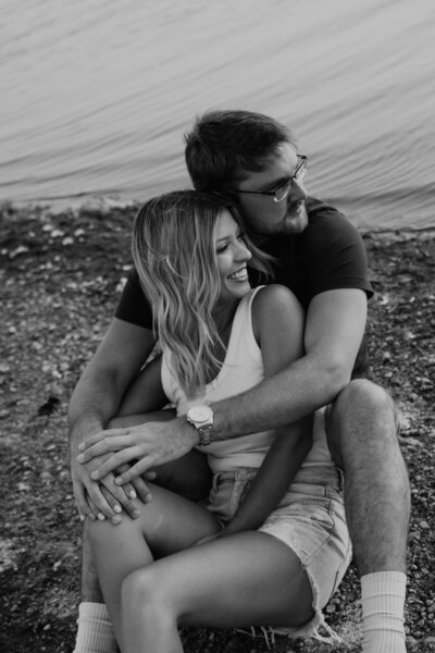 lake-couple-sitting-on-edge-of-lake
