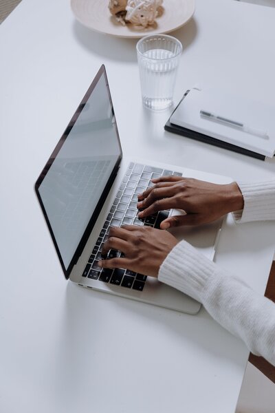 hands typing on computer