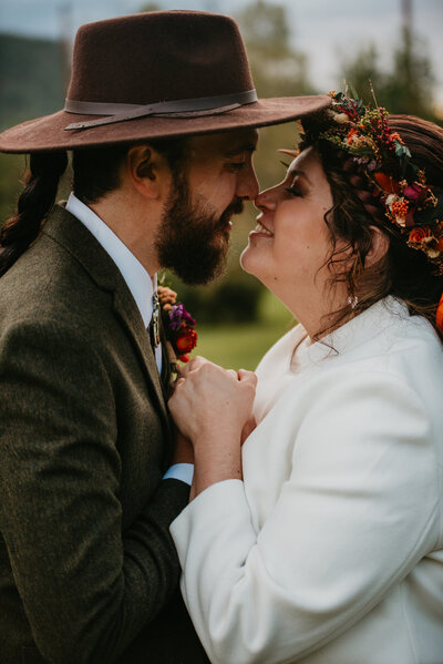A couple embraces each others hands and stares into each others eyes at Paradise Ranch in Pagosa Springs