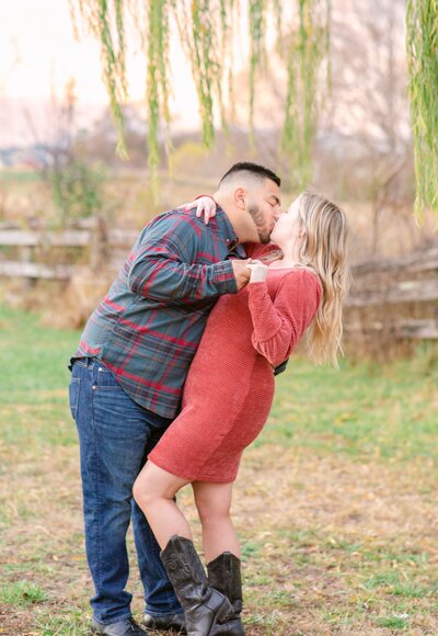 Couple kiss and dip during Engagement Session Photos.