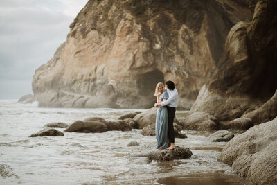 couple standing in the ocean at the oregon coast