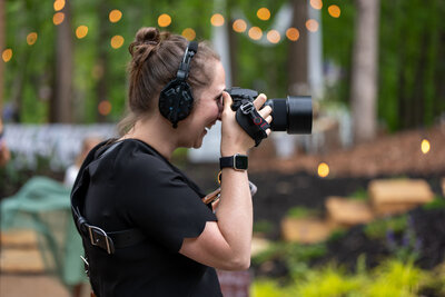 A photographer taking a picture with a headset on 