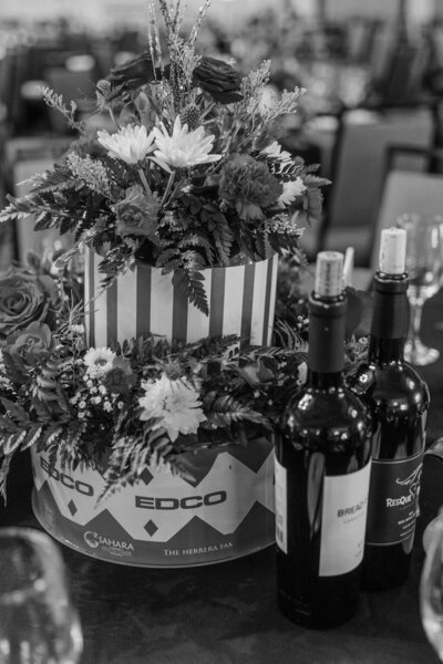 Black and white image of Circus themed floral arrangements and wine bottles at a party planned by Fancy Chancey in San Diego CA