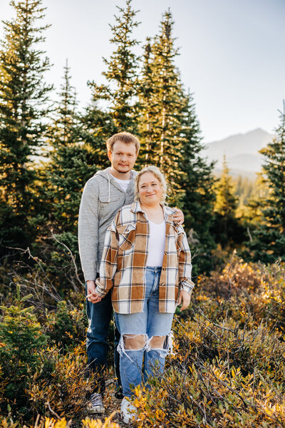 Colorado Elopement Photographer captures couple standing together during fall engagement photos