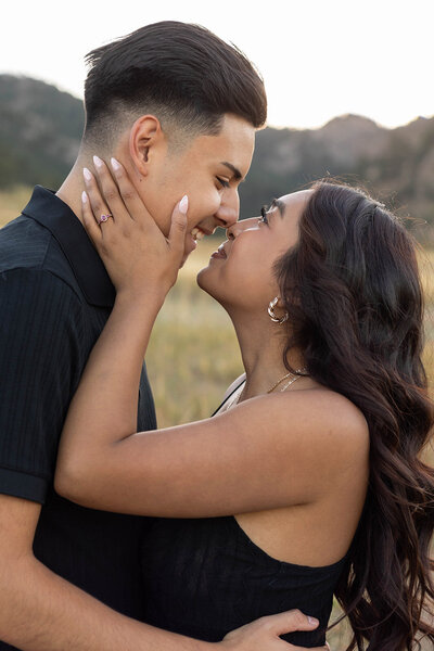 couple wearing black and noses touching