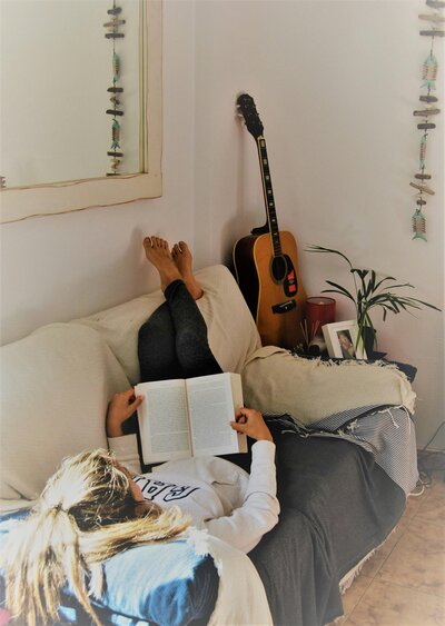 Amy reading a book on the sofa