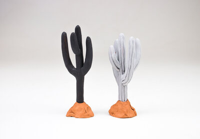 a saguaro cactus shaped ring holder made out of ceramic
