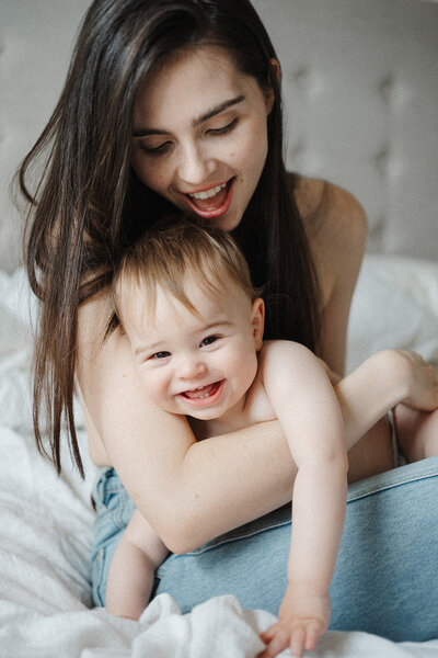 baby laughing in mums arms