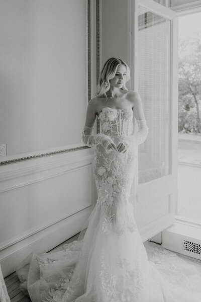 Bride looking down in a form fitting wedding dress