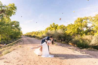 Bride and groom laughing during colorful sunset