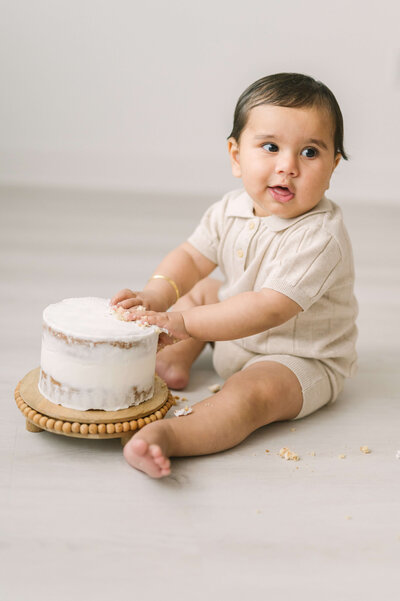 little boy eating smash cake wearing H&M outfit