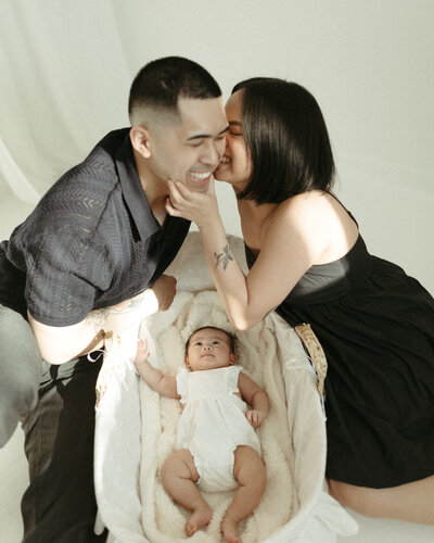 A sweet family of three posing for a warm and natural lifestyle portrait.