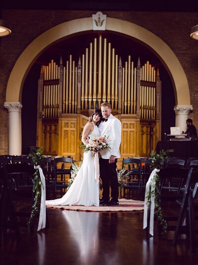 Bride and groom with church organ at Clementine Hall