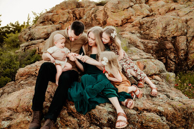 family of five posing in the mountains for fort worth photographer paula goforth. Mom Dad and kids playing with baby sister for family photography