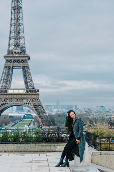 Woman sitting by Eiffel Tower on Solo Traveller Photoshoot in Paris