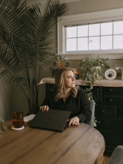 Renee Hoffman in dining room with laptop