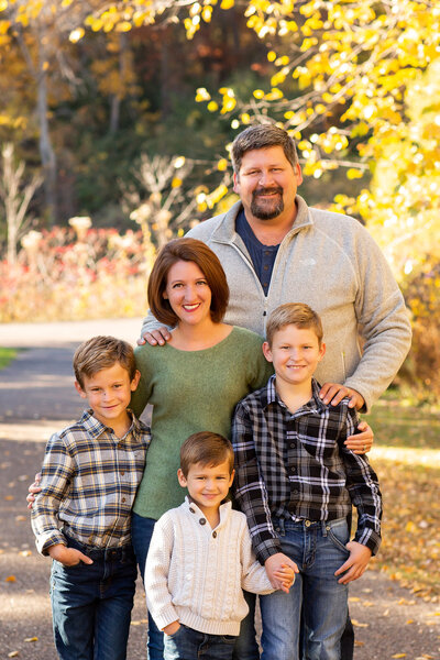 Jess Wayne outside with her husband and three boys