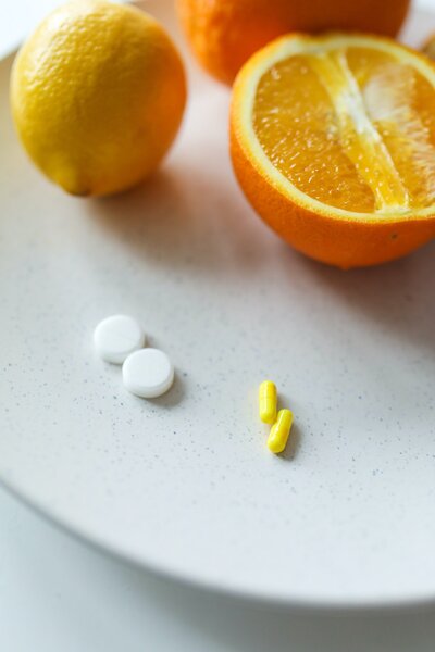 Prenatal vitamins next to oranges
