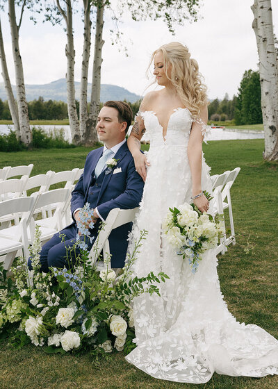 Bride and groom posing together outdoors for wedding portraits in a natural setting.
