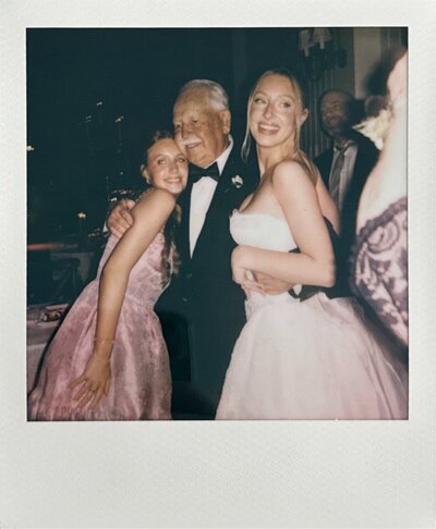a super nostalgic moment of the bride with her grandpa and sister dancing at the wedding reception