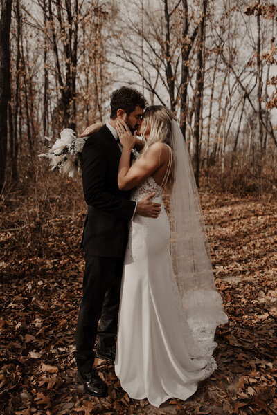 bride and groom kiss after wedding
