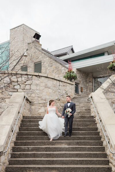 Couple walking down steps on wedding day