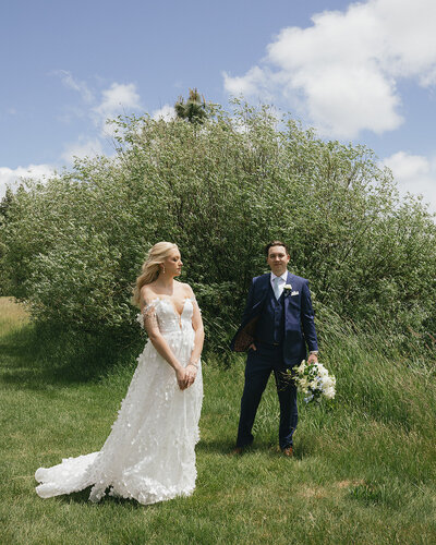bride and groom holding hands while their bridal party is standing around them
