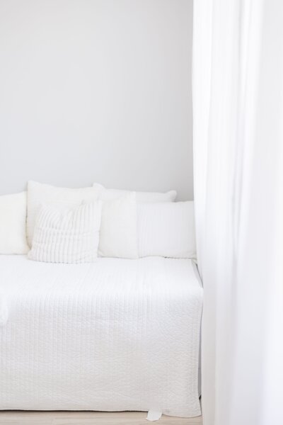 Portrait of a white bed in a bright and neutral northern kentucky photographer studio