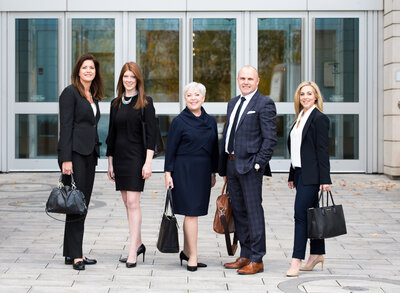 corporate team photo of Usher Hahn Wealth Management team taken outside bank