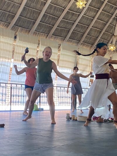 Jared Flores guides ecstatic dance sessions as a form of healing movement therapy, inviting participants to express freely, release emotions, and reconnect through rhythm and embodiment.