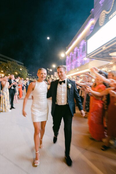 Bride and groom walking through their sparkler exit on their wedding day