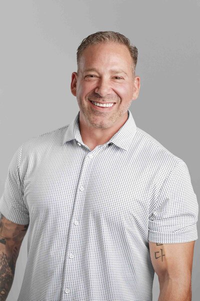 Renton man sitting with hands overlapped in his Headshot Photography session