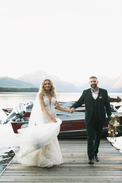 couple walking on dock away from boat