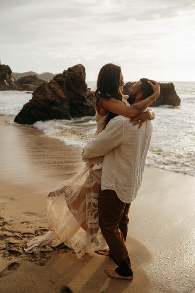 couple celebrating elopement on beach