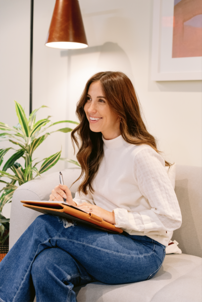 Therapist sitting on couch taking notes