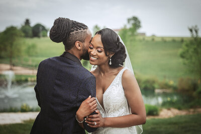 groom whispering into brides ear - baltimore wedding photographer
