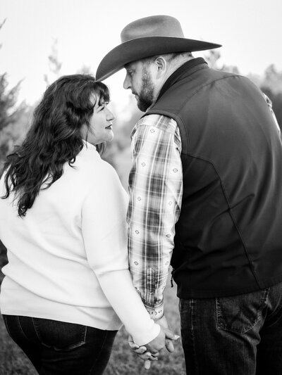 Husband and wife lovingly staring at one another in romantic couples session in Bainbridge, GA, serving Tallahassee, FL.
