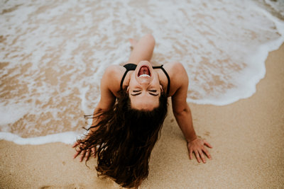 girl laughing in the ocean