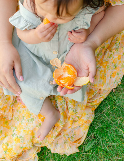 mother and daughter eat oranges together in giethoorn