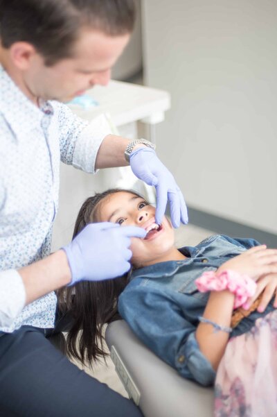 Orthodontist in Allen TX looking at his Pediatric Dental Patient