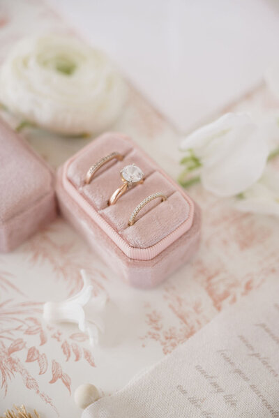 pink ring box with wedding ring and band