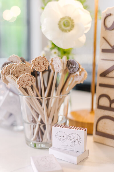Custom drink stir sticks with dog illustrations and personalized matchbooks designed by Cove Mill Design Co.