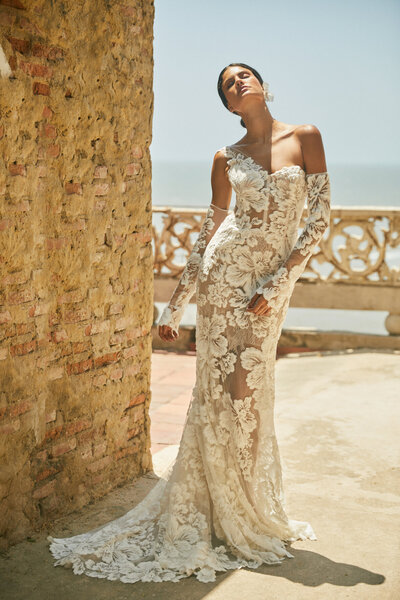 black and white image bride wearing strapless satin wedding dress with long train