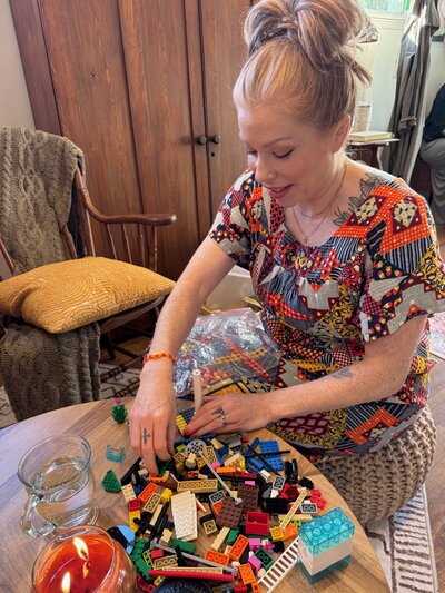 LEGO Serious Play Corporate Workshop - woman building a model at a Mastermind Retreat.