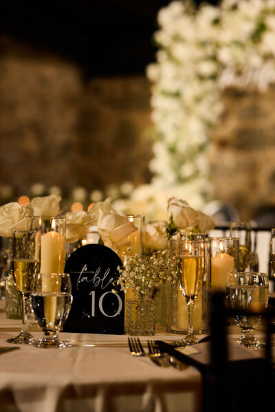 Wedding reception table with candles and table number décor