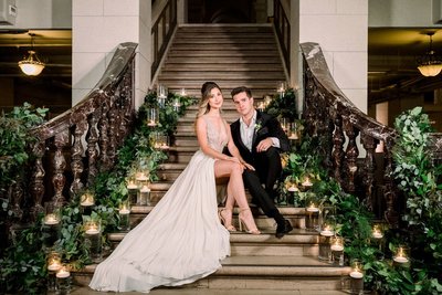 Bride and Groom pose together sitting on stairs at The Majestic Downtown in Los Angeles